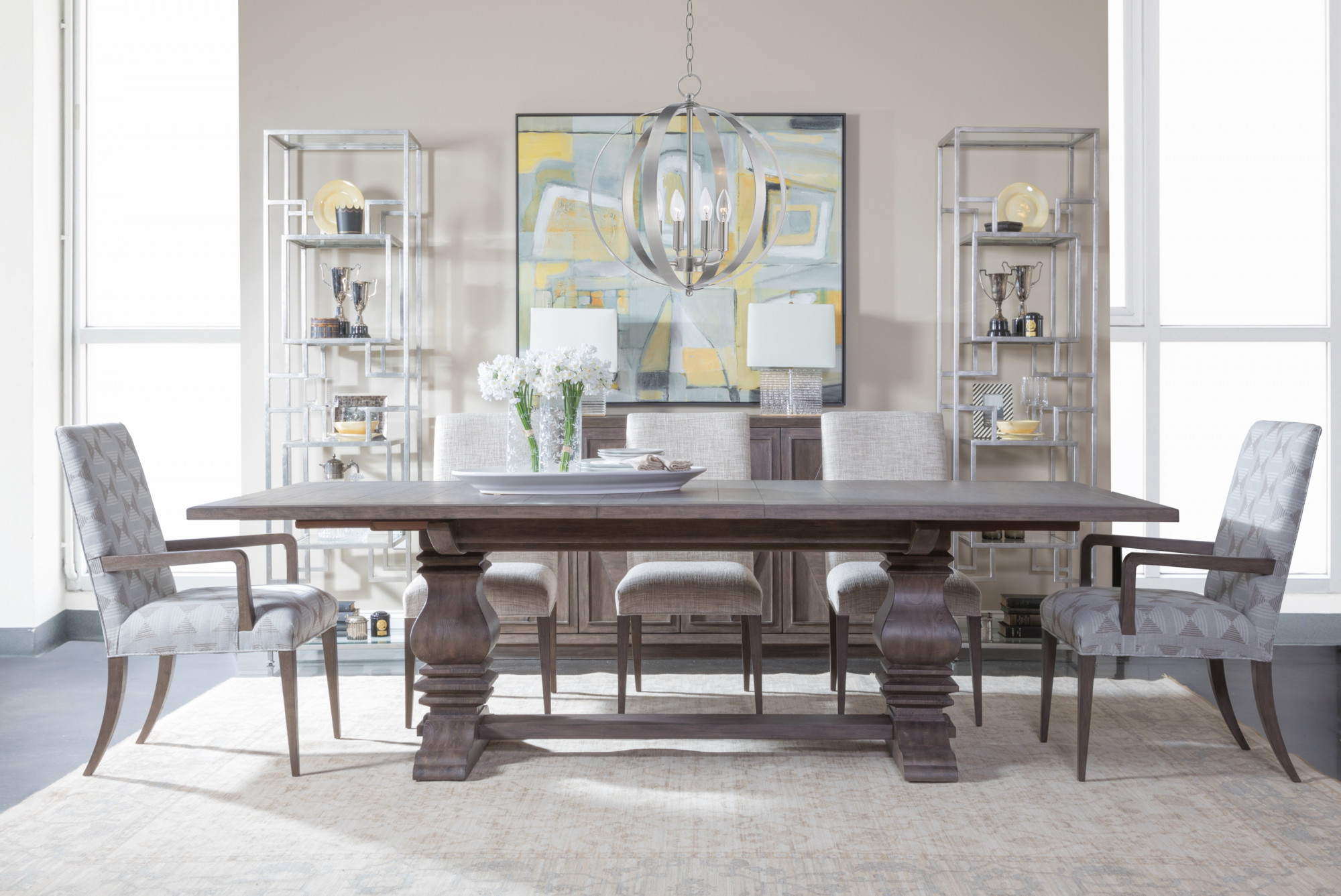 A finished dining room by Design Studio of Somerville — furniture, lighting, and styling Finished dining room designed by Design Studio of Somerville: trestle dining table, upholstered chairs, orb chandelier, and curated shelving — real project imagery from their site